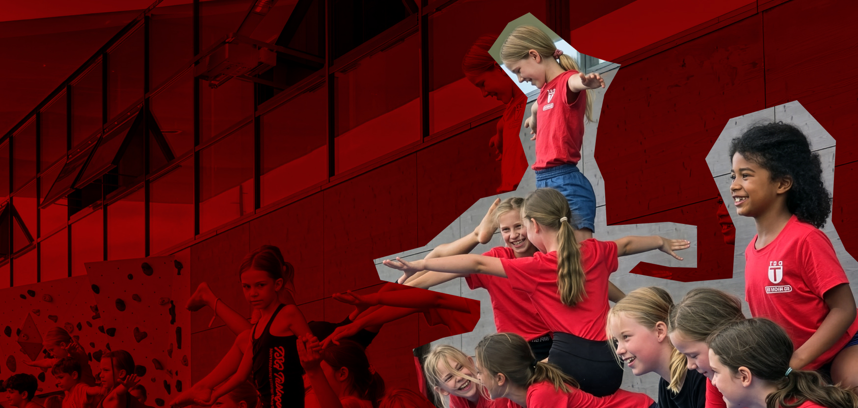 Gruppe von Kinderturnerinnen in roten Shirts führt Akrobatikübungen an einer Kletterwand aus, lächelnd und posierend, im Hintergrund eine graue Wand.